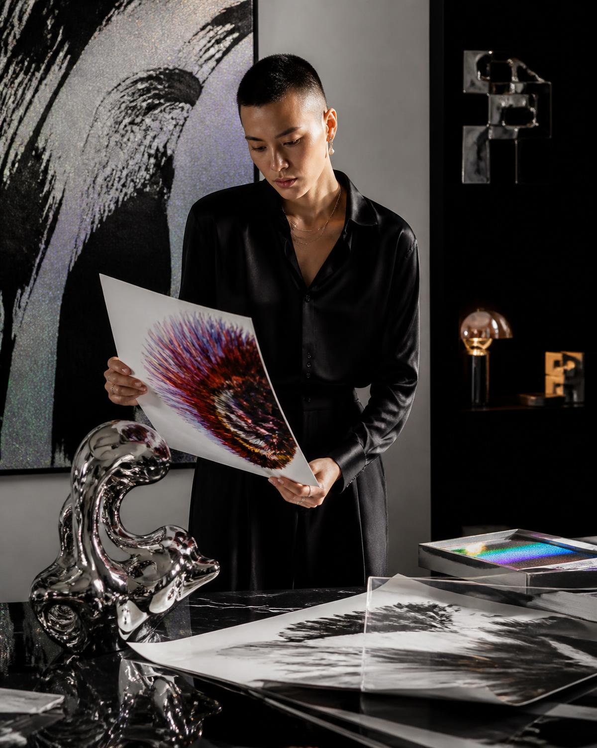Collector examining a contemporary edition in a dramatic editorial studio